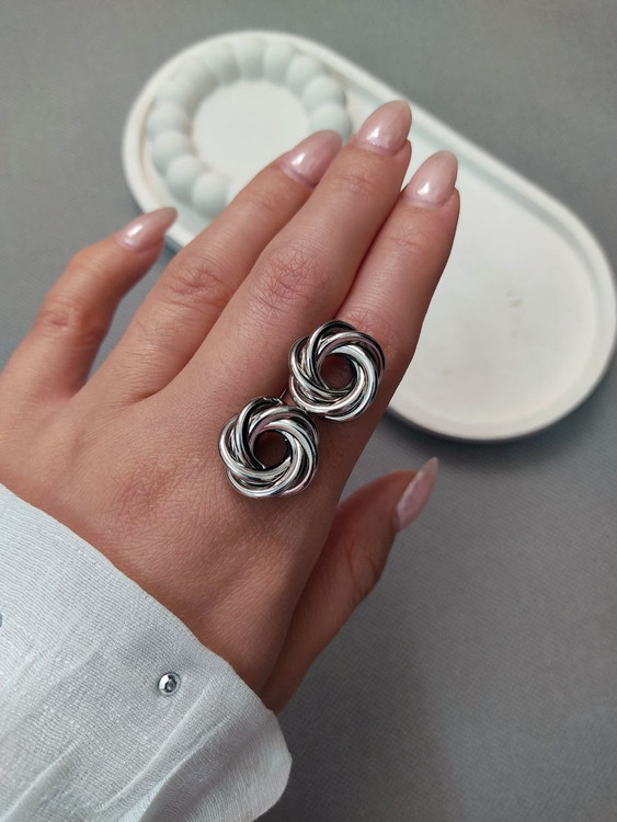 جزئیات گوشواره بافت درهم تنیده روی دست مدل