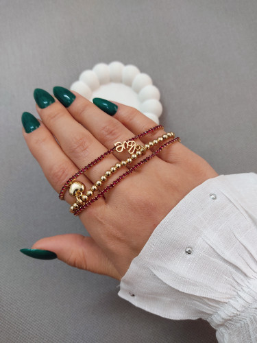 دستبند زنانه مدل لورا با مهره طلایی و بند زرشکی